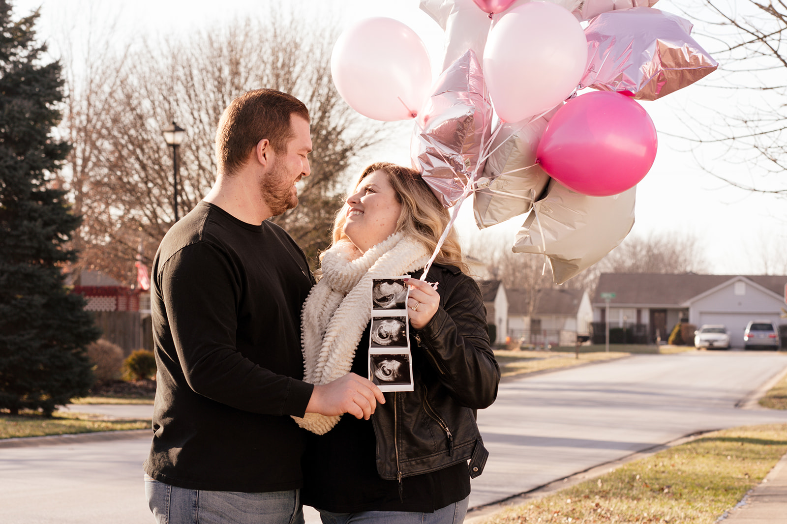 pregnancy announcement with pink balloons
